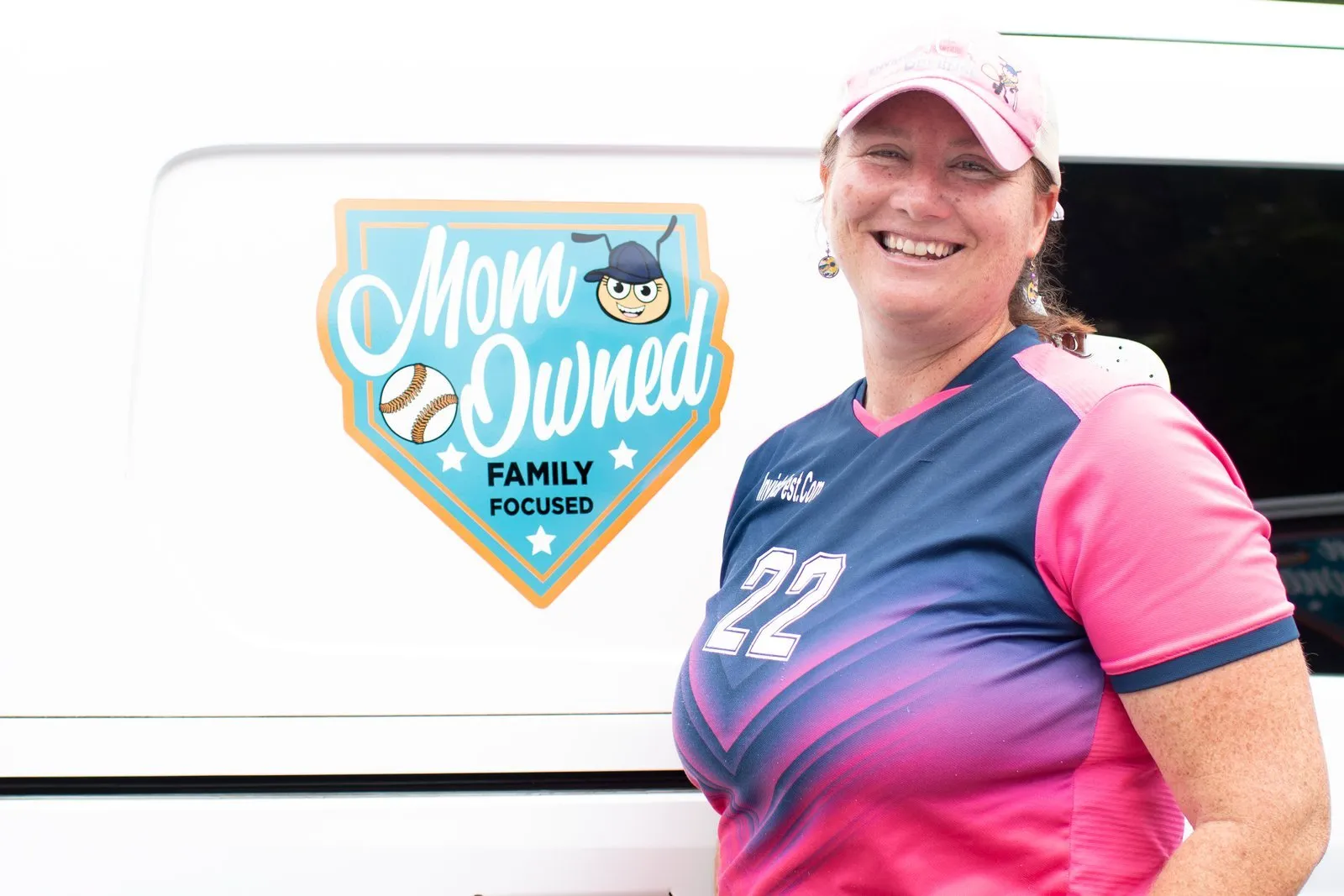 Owner Elizabeth Gilbert next to the Mom Owned logo on an Invicta van