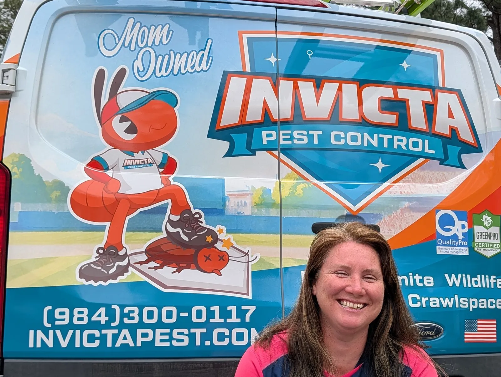 Owner Elizabeth Gilbert at the back of an Invicta Pest Control van