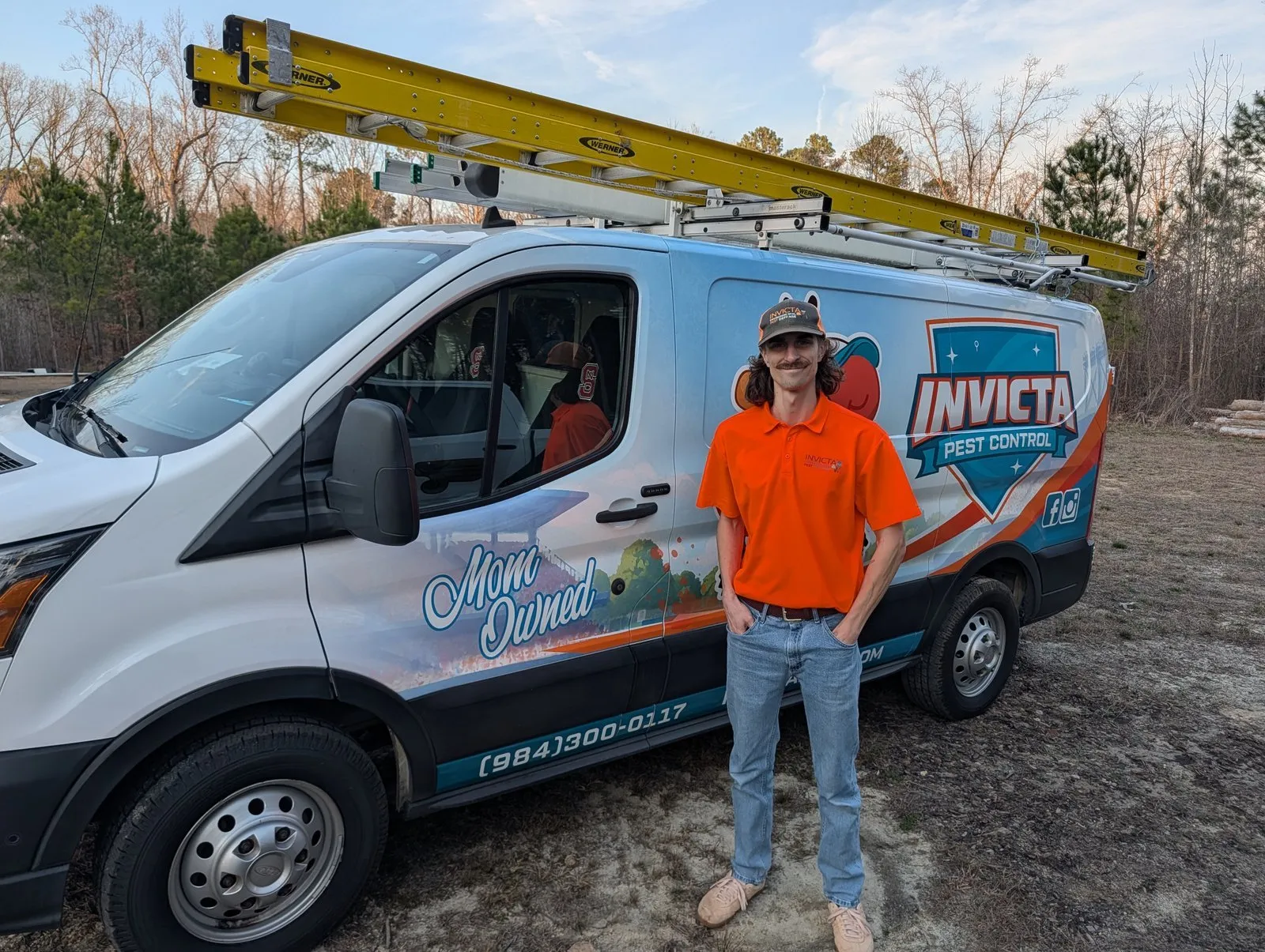 Invicta Pest Control technician beside his van