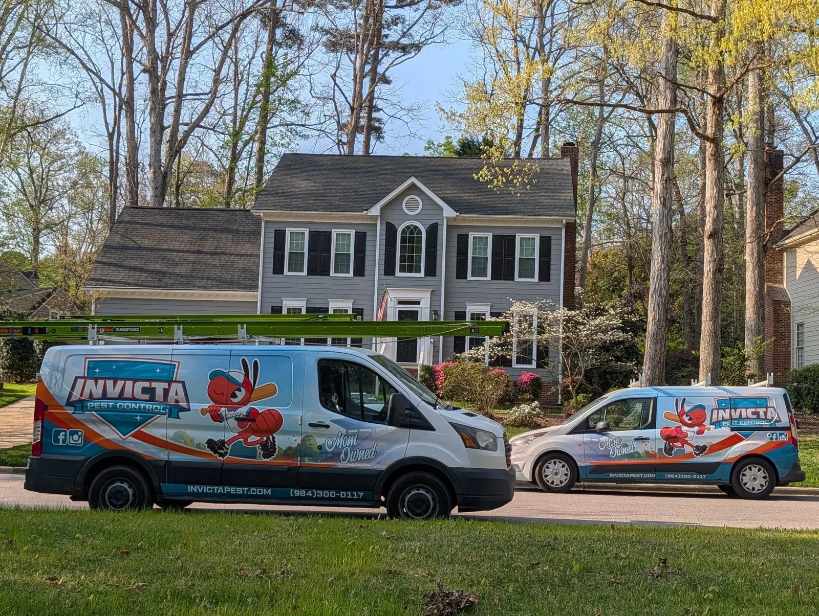 Two Invicta Pest Control vans outside a customer’s home