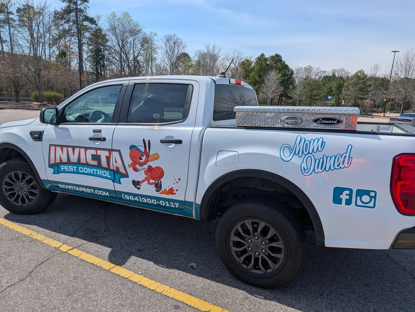 Invicta Pest Control truck with the Mom Owned logo