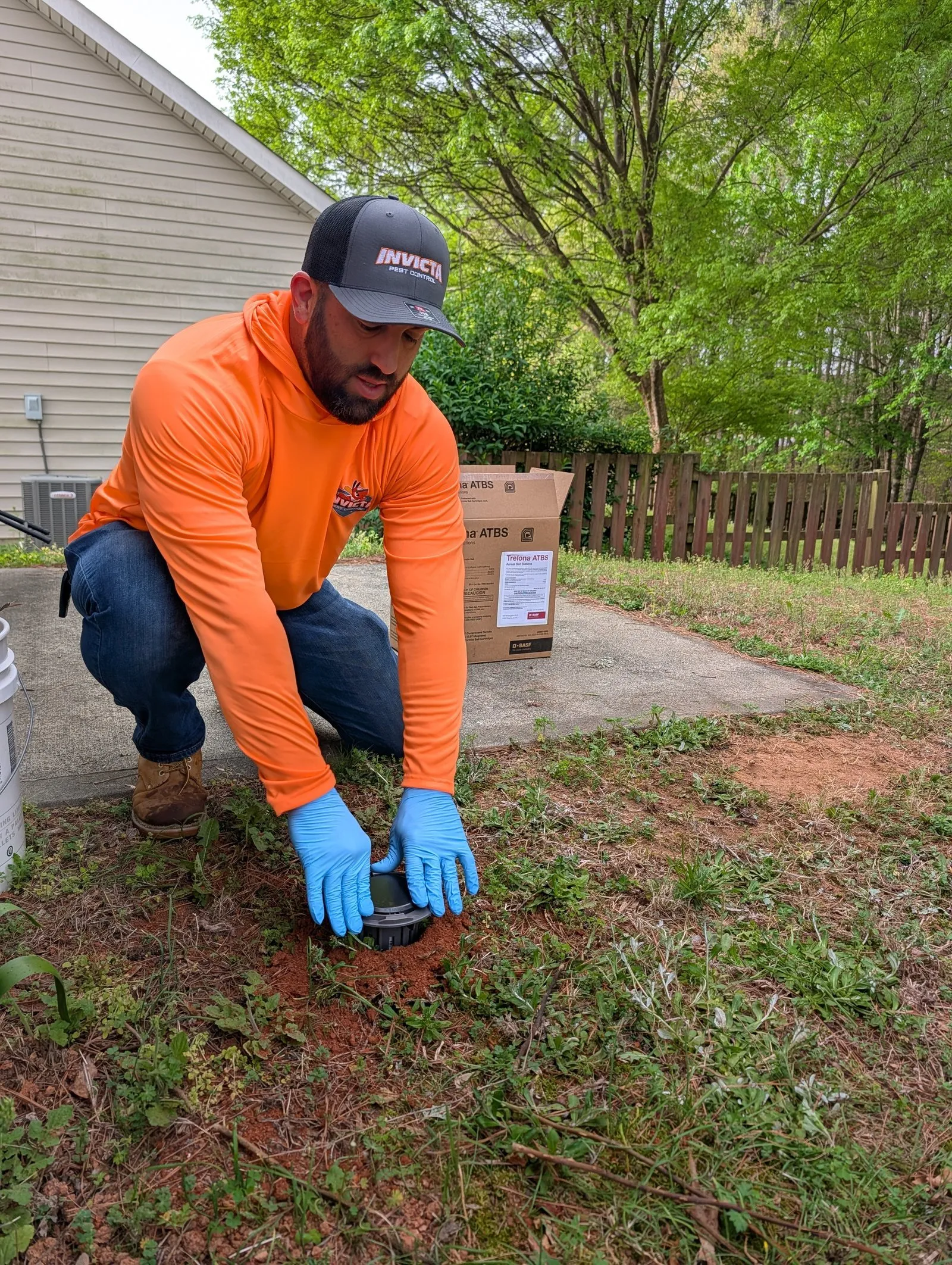 Invicta Pest Control technician at work in a customer’s yard