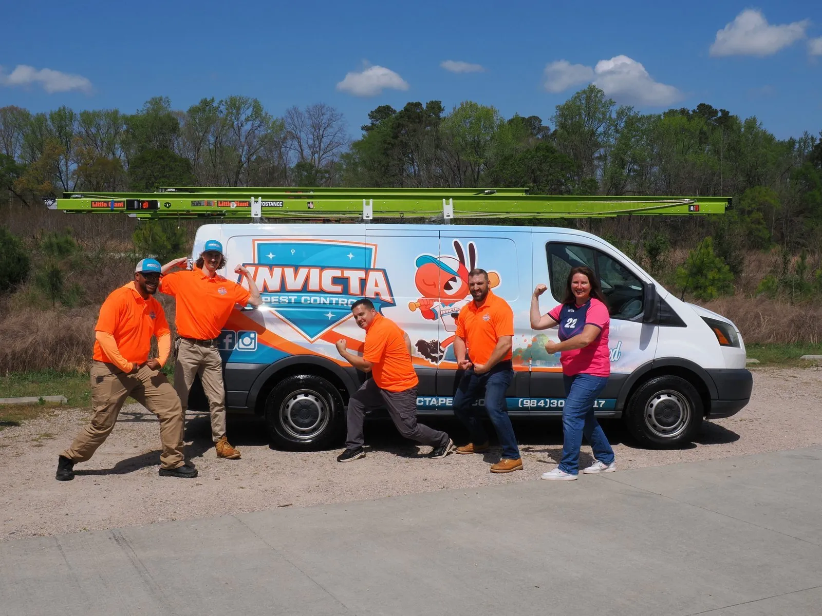 The Invicta Pest Control team clowning around in front of a van
