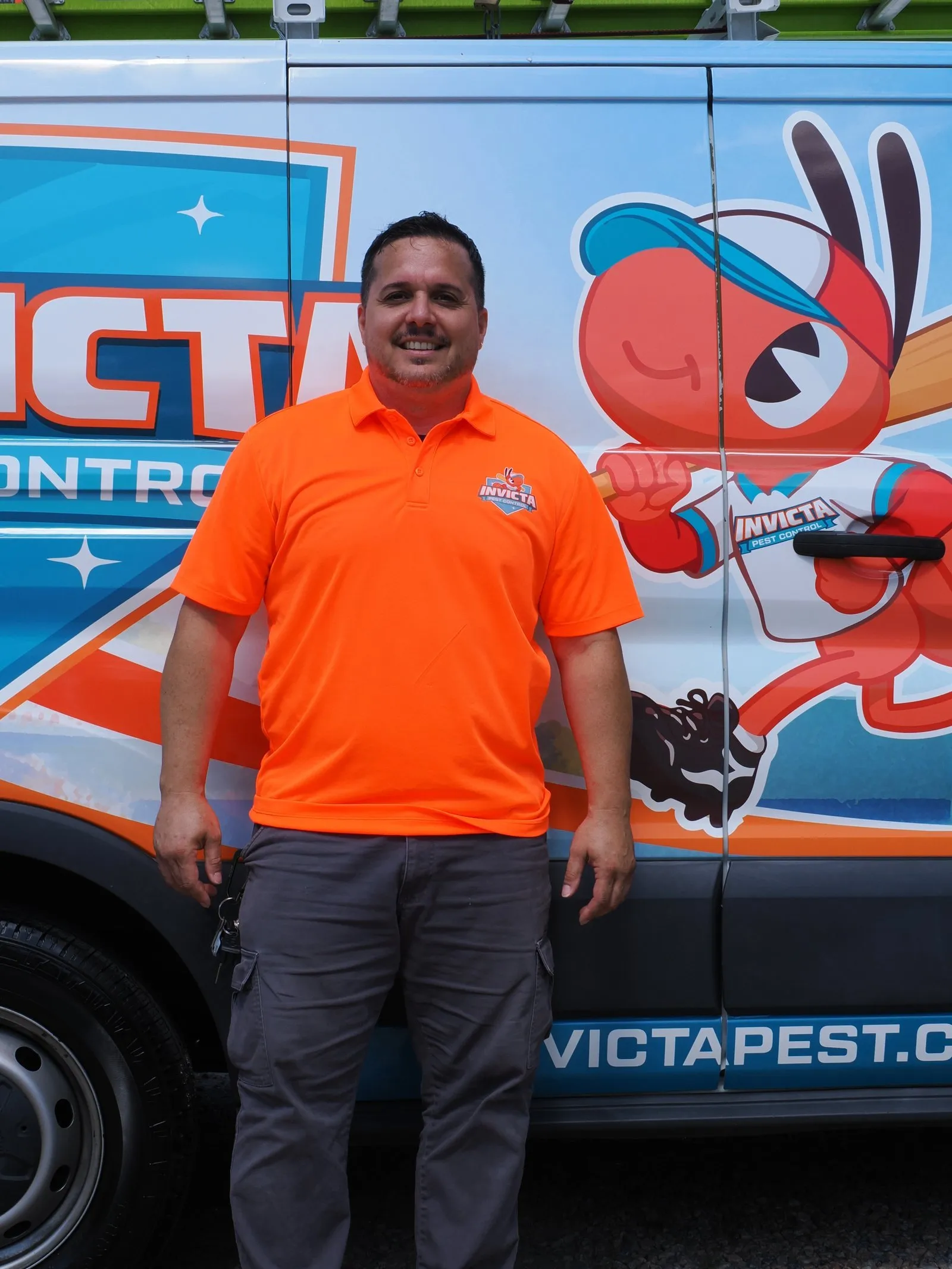 Invicta Pest Control technician in front of an Invicta van