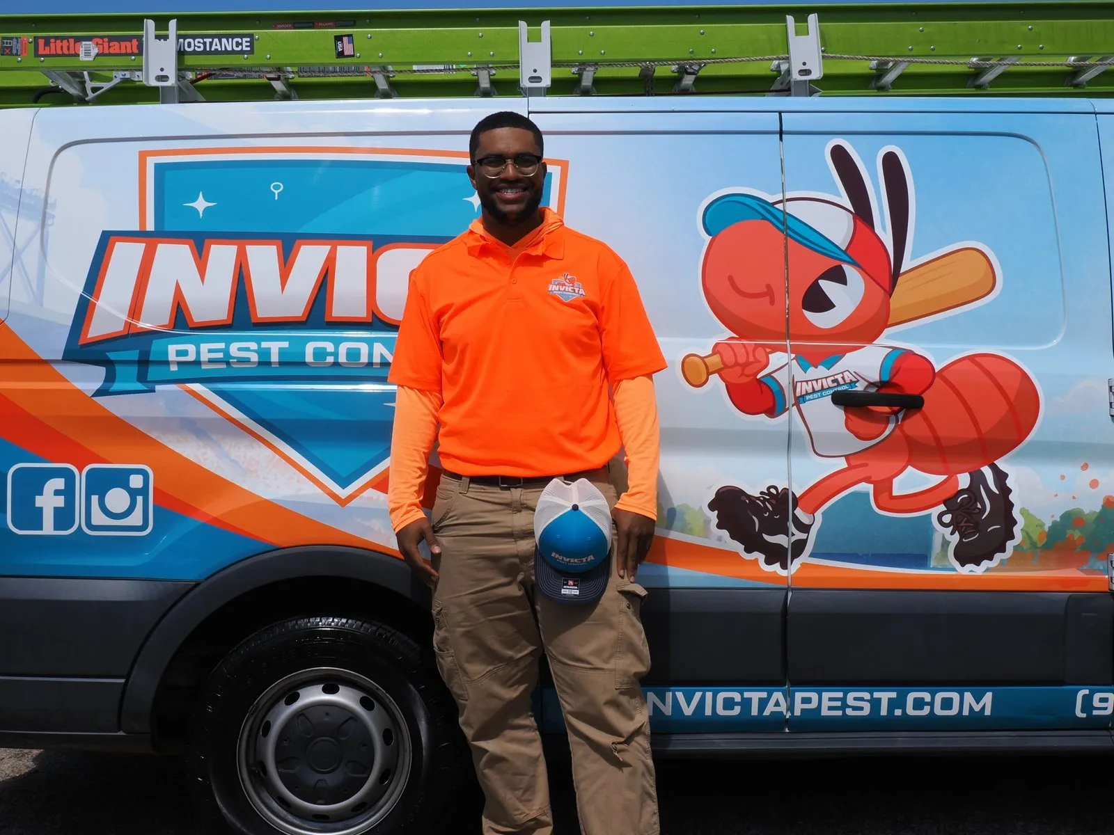 Invicta Pest Control technician in front of an Invicta van