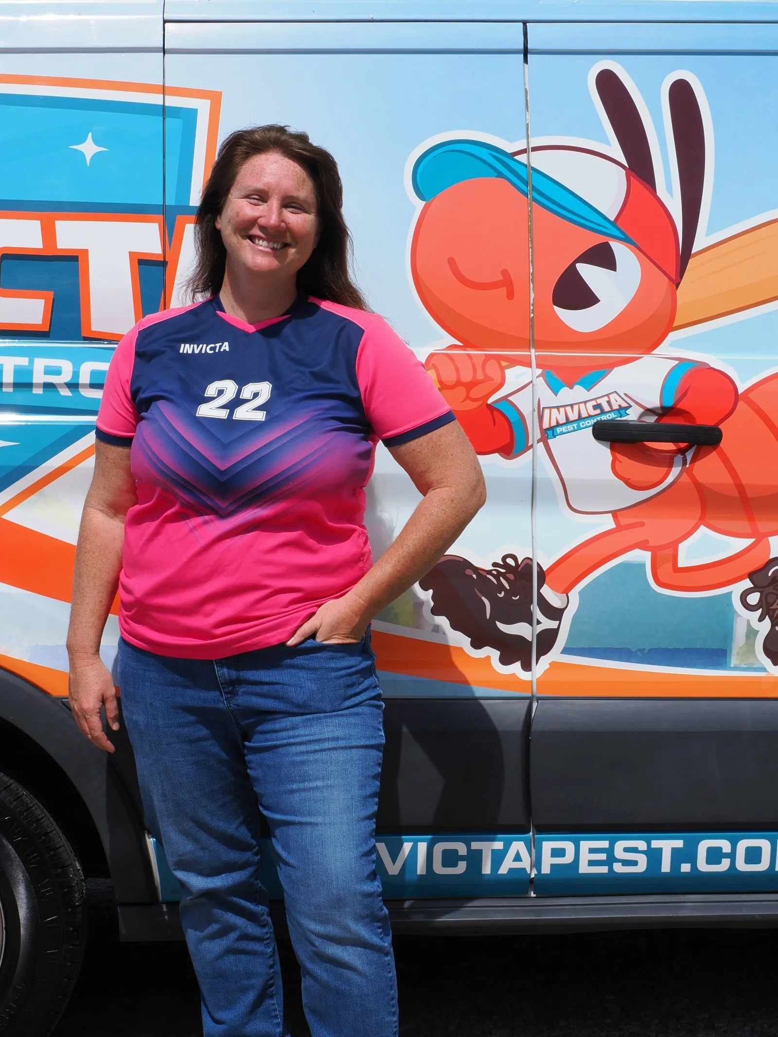 Elizabeth Gilbert in her Invicta jersey in front of a van