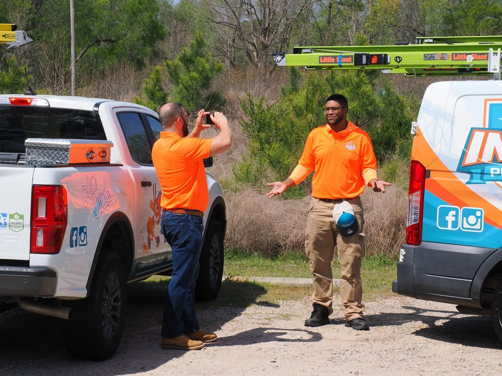 Two Invicta technicians at their trucks
