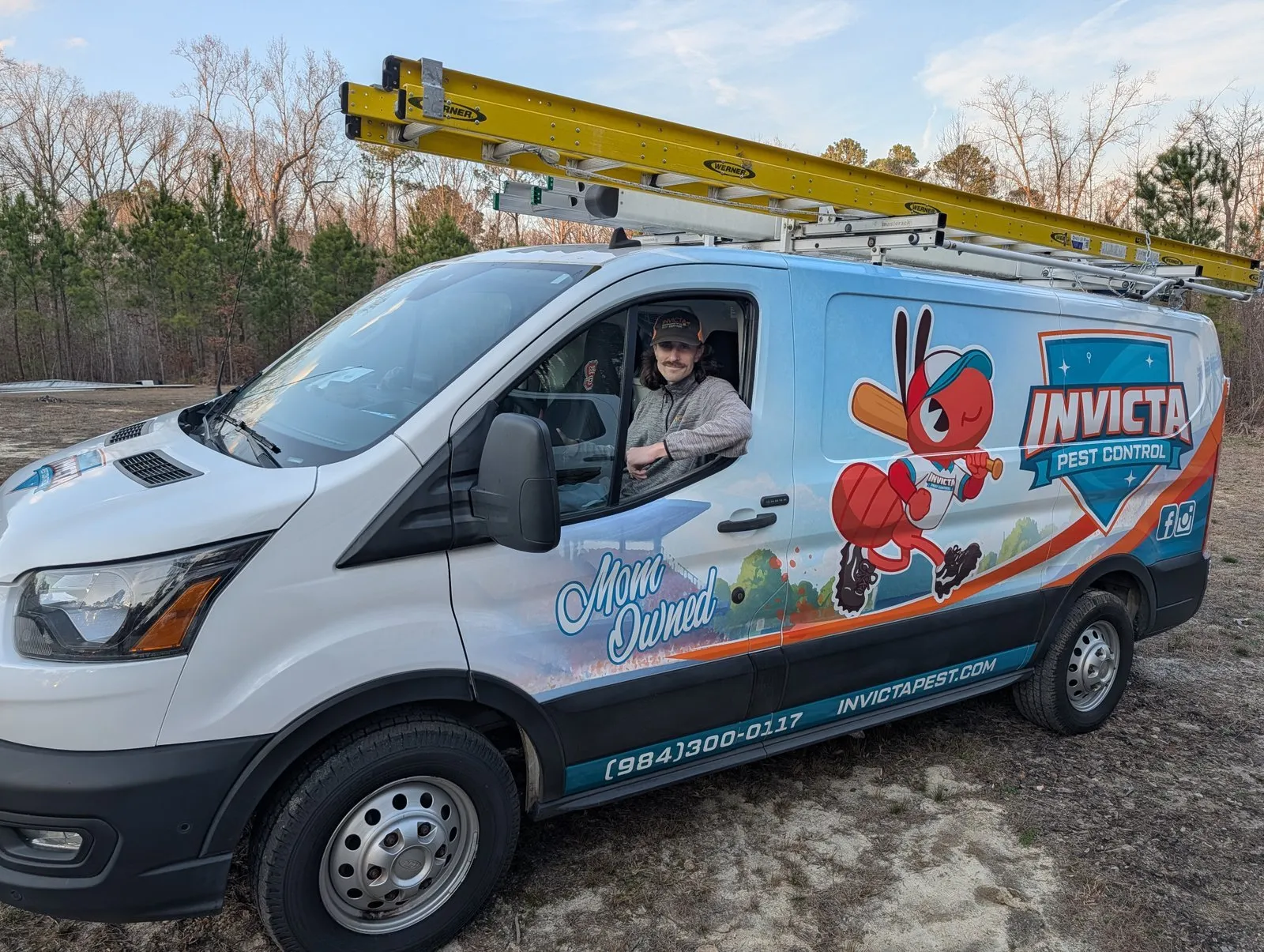 Invicta technician inside an Invicta Pest Control van